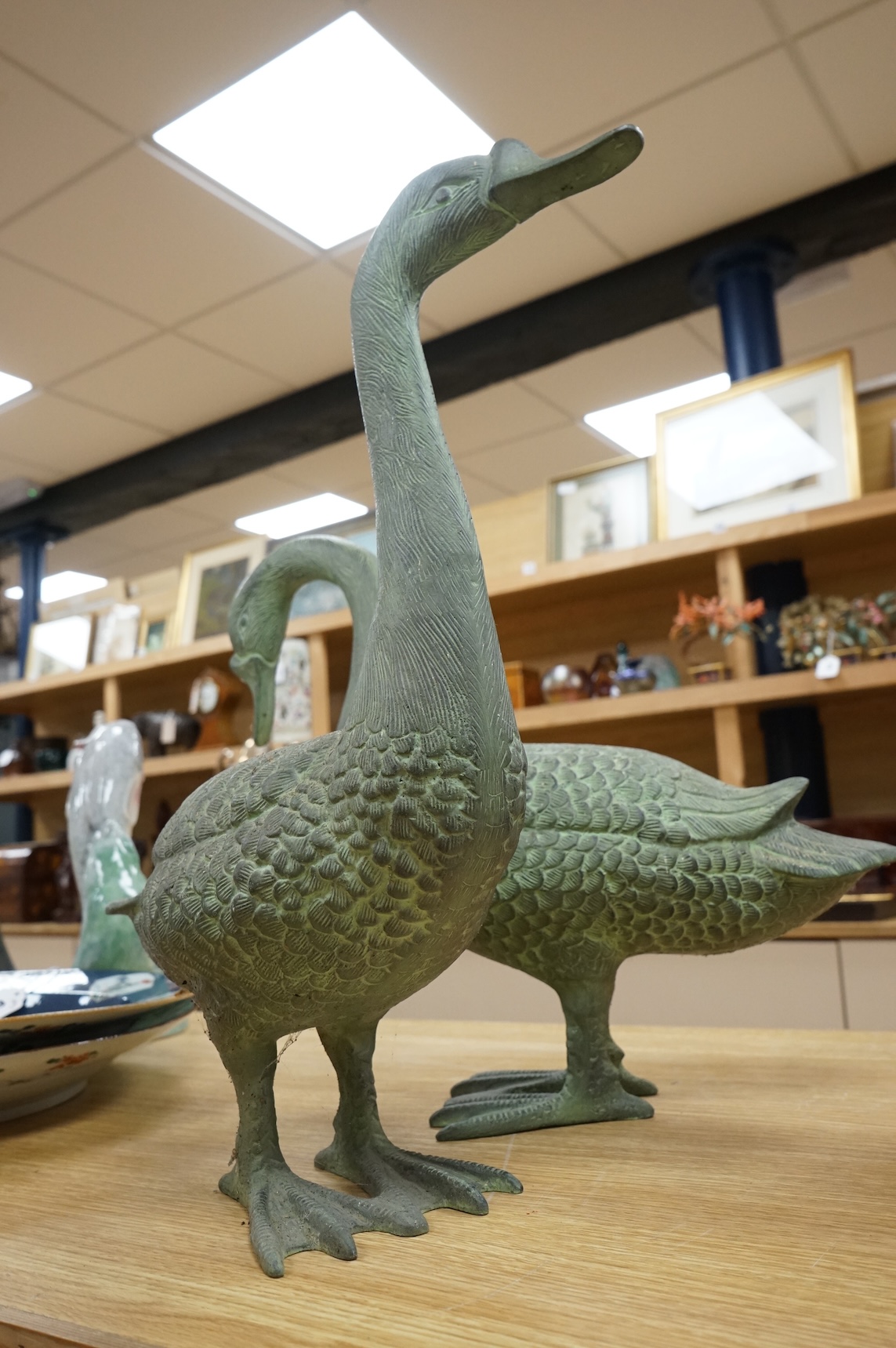 A pair of patinated spelter models of geese, 49cm